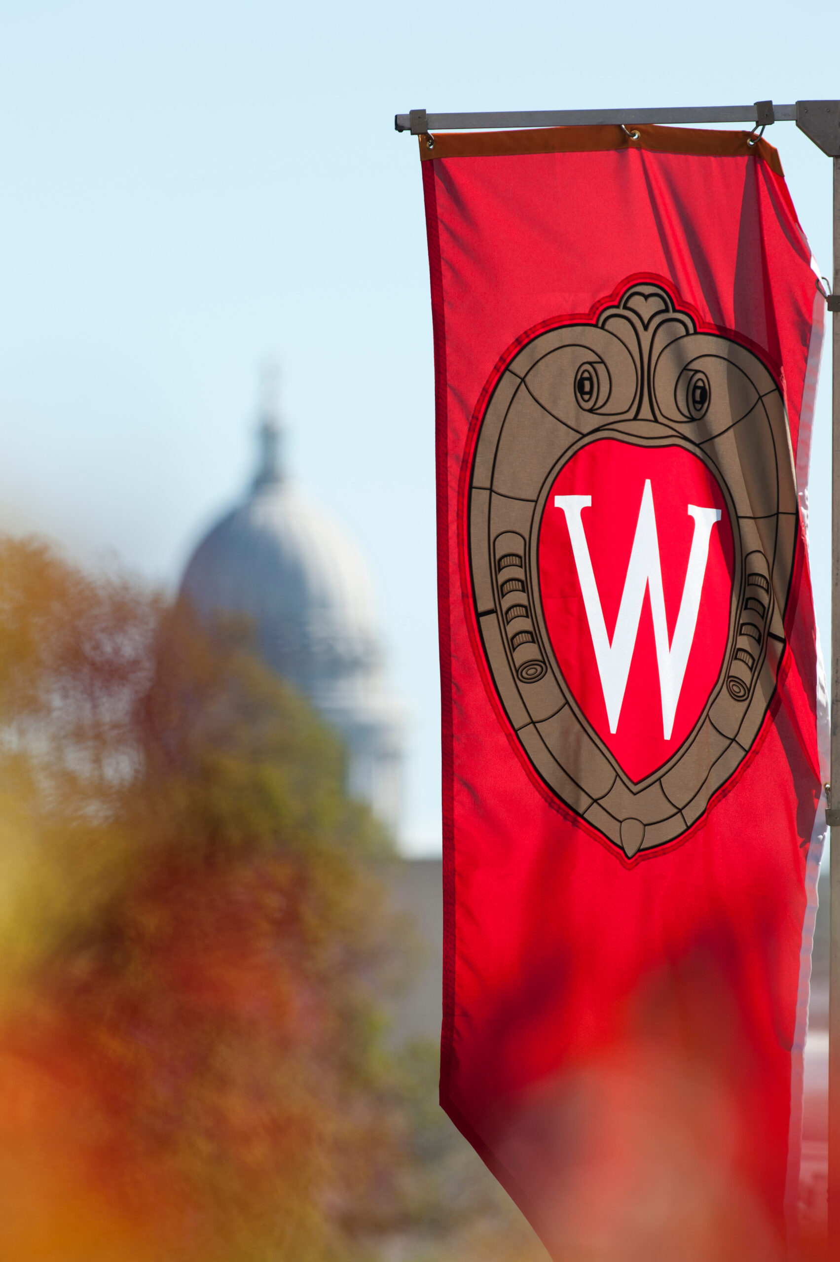 A "W" crest banner hanging on Bascom Hill at the University of Wisconsin